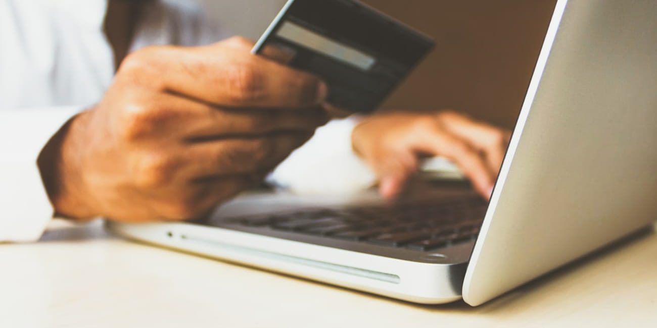 Person using a laptop for online shopping, representing how studying which themes power successful ecommerce stores helps you build a better store of your own